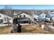 Cozy backyard featuring a covered patio, spacious lawn, and a wooden fence, perfect for outdoor living at 5436 S Versailles Way, Aurora, CO 80015