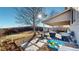 Enjoy the spacious backyard with a covered patio, seating, and playful sandbox at 5436 S Versailles Way, Aurora, CO 80015