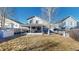 This backyard features a covered patio with an outdoor kitchen and plenty of space to entertain at 5436 S Versailles Way, Aurora, CO 80015