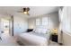 Comfortable bedroom with a ceiling fan, light walls, neutral carpet and a window for natural light at 5436 S Versailles Way, Aurora, CO 80015