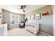Charming Bedroom with a crib, rocking chair, changing table and art pieces on the wall at 5436 S Versailles Way, Aurora, CO 80015