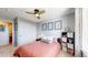 Bright bedroom with a ceiling fan, light walls, neutral carpet, and a window for natural light at 5436 S Versailles Way, Aurora, CO 80015
