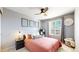 Cozy bedroom with natural light from a window and a ceiling fan above the bed at 5436 S Versailles Way, Aurora, CO 80015