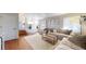 Cozy living room with hardwood floors, comfortable sofas, accent pillows, and stairway at 5436 S Versailles Way, Aurora, CO 80015