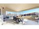 This covered patio features ample seating and a dining area, perfect for enjoying the backyard view at 5436 S Versailles Way, Aurora, CO 80015