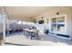 Enjoy outdoor living on this covered patio with a dining table, mounted TV, and ample space for entertaining at 5436 S Versailles Way, Aurora, CO 80015