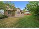 Well-maintained lawn surrounds brick home with mature trees at 7914 S Clayton Cir, Centennial, CO 80122