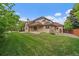 Large backyard featuring a well-maintained lawn and covered patio, perfect for outdoor entertaining at 7914 S Clayton Cir, Centennial, CO 80122