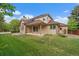Large backyard featuring a well-maintained lawn and covered patio, perfect for outdoor entertaining at 7914 S Clayton Cir, Centennial, CO 80122