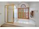 Luxurious bathroom showcasing a soaking tub and a separate glass-enclosed shower at 7914 S Clayton Cir, Centennial, CO 80122