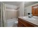 Neutral bathroom features a tiled shower with a bathtub, vanity, and a large mirror at 7914 S Clayton Cir, Centennial, CO 80122