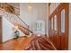 Welcoming foyer with a grand staircase, hardwood floors, and a decorative area rug at 7914 S Clayton Cir, Centennial, CO 80122