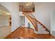 Bright foyer with hardwood floors, curved staircase, and elegant chandelier at 7914 S Clayton Cir, Centennial, CO 80122