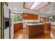 Bright kitchen with wood cabinets, white appliances, and an island cooktop at 7914 S Clayton Cir, Centennial, CO 80122