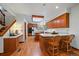 Bright kitchen boasts light-colored countertops, hardwood floors, wooden cabinetry, and a skylight at 7914 S Clayton Cir, Centennial, CO 80122