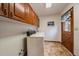 Functional laundry room with washer, dryer, and wooden cabinets at 7914 S Clayton Cir, Centennial, CO 80122