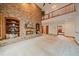 Spacious living room with brick fireplace and access to the upper level at 7914 S Clayton Cir, Centennial, CO 80122