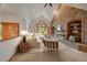 Cozy living room features a brick fireplace, vaulted ceiling, and large windows at 7914 S Clayton Cir, Centennial, CO 80122
