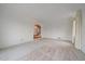 Large, empty living room with wall to wall carpet and an arched doorway at 7914 S Clayton Cir, Centennial, CO 80122