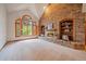 Open living room featuring a brick fireplace and a large window with wood shutters at 7914 S Clayton Cir, Centennial, CO 80122