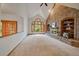 Expansive living room featuring a brick fireplace and a vaulted ceiling at 7914 S Clayton Cir, Centennial, CO 80122