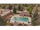 Community pool area with a large pool, plenty of lounge chairs, and a nearby clubhouse for residents at 7914 S Clayton Cir, Centennial, CO 80122