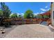 Fenced backyard includes a gravel area, stone pavers and steps to a deck at 1446 Braewood Ave, Highlands Ranch, CO 80129