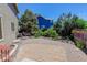Backyard features paver patio, rock landscaping, mature trees, shrubs and lawn at 1446 Braewood Ave, Highlands Ranch, CO 80129