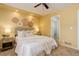 Sunlit bedroom with a decorative wall, a ceiling fan, bedside tables, and a comfortable bed for restful nights at 1446 Braewood Ave, Highlands Ranch, CO 80129
