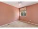 A well-lit bedroom featuring carpet, a window with blinds, and a ceiling fan at 1446 Braewood Ave, Highlands Ranch, CO 80129