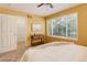 Cozy bedroom with large window, side table, and a door leading to a walk-in closet at 1446 Braewood Ave, Highlands Ranch, CO 80129