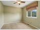 This carpeted bedroom features a ceiling fan and a window offering natural light at 1446 Braewood Ave, Highlands Ranch, CO 80129