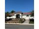 Front view of clubhouse with clay tile roof, decorative landscaping, and security gate at 1446 Braewood Ave, Highlands Ranch, CO 80129