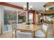 Bright dining area features a round table, stylish chairs, a sliding door leading to the deck, and a cozy fireplace at 1446 Braewood Ave, Highlands Ranch, CO 80129