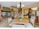 Comfortable dining area with a round table, stylish chairs, and an open layout leading to the living room and kitchen at 1446 Braewood Ave, Highlands Ranch, CO 80129