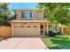Charming two-story home with a stone facade and a well-maintained front yard and attached garage at 1446 Braewood Ave, Highlands Ranch, CO 80129