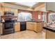 Functional kitchen with a black appliance package, countertop seating, and ample cabinet space at 1446 Braewood Ave, Highlands Ranch, CO 80129