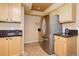 Efficient kitchen layout with stainless steel refrigerator, granite counters, and classic wood cabinetry at 1446 Braewood Ave, Highlands Ranch, CO 80129