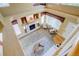 This is a view from the upper level of the living room, which has abundant light and a fireplace at 1446 Braewood Ave, Highlands Ranch, CO 80129