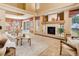 Spacious living room featuring a cozy fireplace and neutral decor with access to the outdoor patio at 1446 Braewood Ave, Highlands Ranch, CO 80129