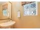 A powder room showcasing a vessel sink, a towel ring, and a glass block window at 1446 Braewood Ave, Highlands Ranch, CO 80129