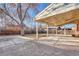 Covered back patio with concrete flooring, offering ample outdoor space at 1051 Lima St, Aurora, CO 80010