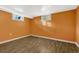 Finished basement features warm-toned walls and wood-look flooring at 1051 Lima St, Aurora, CO 80010