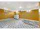 Basement laundry area with tile flooring and bright overhead lighting at 1051 Lima St, Aurora, CO 80010