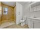 This bathroom features a tiled shower, toilet, tiled floor, sink, and medicine cabinet at 1051 Lima St, Aurora, CO 80010