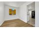 A simple dining area featuring light hardwood flooring and a view to the kitchen at 1051 Lima St, Aurora, CO 80010