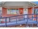 A welcoming front porch with access ramp leads to the front door of a classic brick home at 1051 Lima St, Aurora, CO 80010