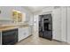 A simple kitchen featuring a black refrigerator and black dishwasher at 1051 Lima St, Aurora, CO 80010