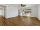 Bright living room features hardwood floors, fresh white paint, and a large window with neighborhood views at 1051 Lima St, Aurora, CO 80010