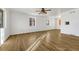 Sun-filled living room showcasing hardwood floors, white walls, and windows providing ample natural light at 1051 Lima St, Aurora, CO 80010